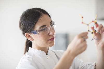 Scientist female with lab glasses, tablet and sample in a lab