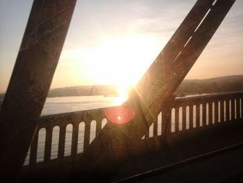 Close-up of railing against sky during sunset