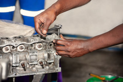 Cropped hand of man working in garage