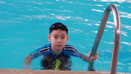 Boy swimming in pool