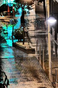 High angle view of wet street by swimming pool at night