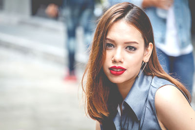 Close-up portrait of beautiful woman in city