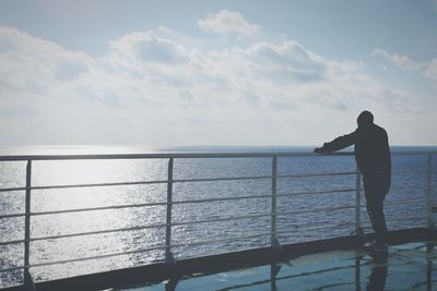 Man looking at sea against sky