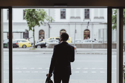 Rear view of woman walking on street in city