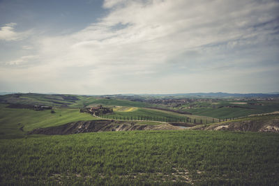 Scenic view of green landscape against sky