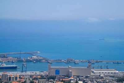 High angle view of sea by buildings against sky