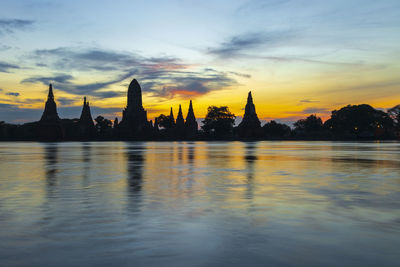 Silhouette of buildings against sky during sunset