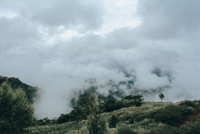 Smoke emitting from volcanic mountain against sky