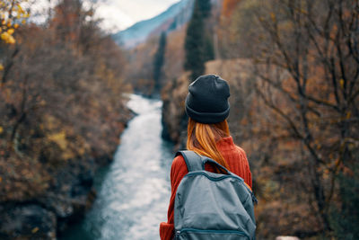 Rear view of woman standing in forest