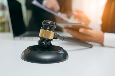 Close-up of a hand holding tea light candles on table