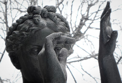 Hands and face of female bronze statue