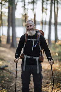 A 62 year old male appalachian trail hiker with a beard and a pack.