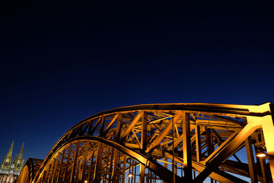 Low angle view of illuminated ferris wheel against sky at night