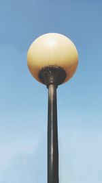 Low angle view of street light against blue sky