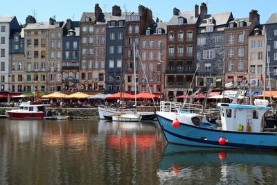 Boats in canal with buildings in background