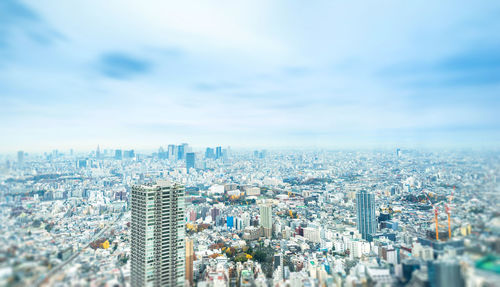 High angle view of modern buildings in city against sky