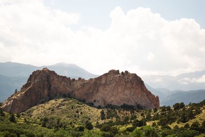 Scenic view of mountains against cloudy sky