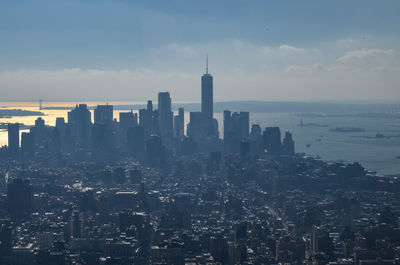 View of cityscape against cloudy sky