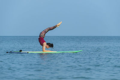 Yogini. yoga on paddle board