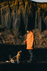 Rear view of man walking with dog