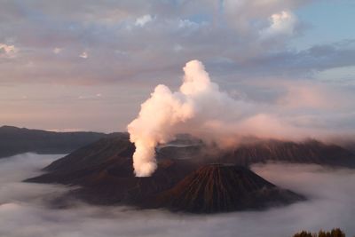 Active volcano at bromo-tengger-semeru national park against cloudy sky