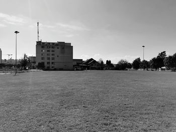 Houses on field against sky