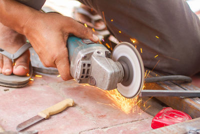 Low section of man welding metal in workshop