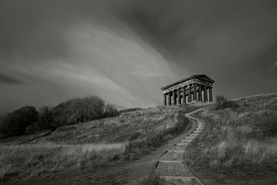 Built structure on land against sky