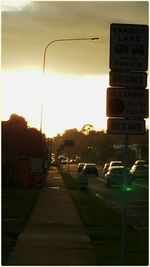 Road sign at sunset