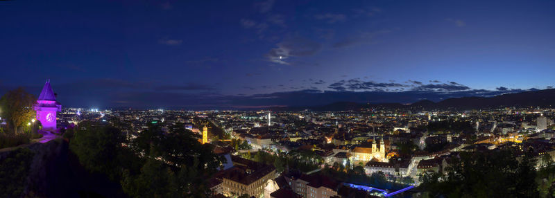 High angle view of illuminated cityscape against sky at night