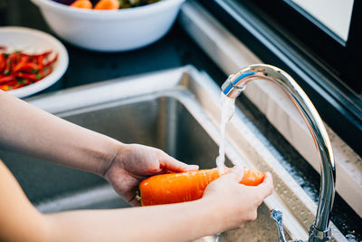 Cropped hand of woman holding food