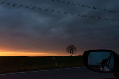 Silhouette car against sky during sunset