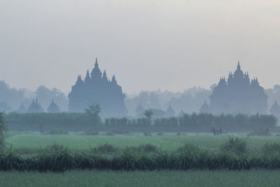 View of temple on field against sky