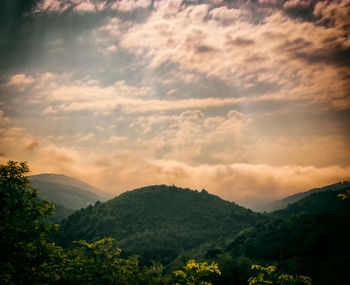 Scenic view of mountains against sky at sunset