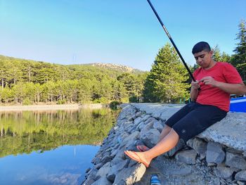 A young fisherman at prodromos dam on troodos mountains in cyprus republic 