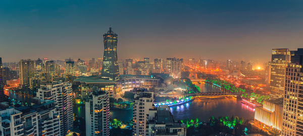 High angle view of city lit up at night