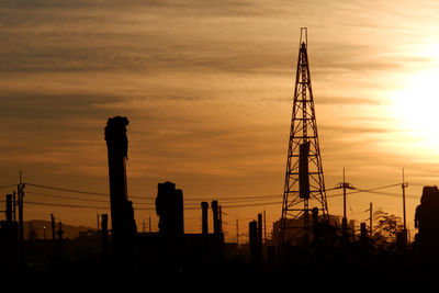 Low angle view of silhouette crane against sky during sunset