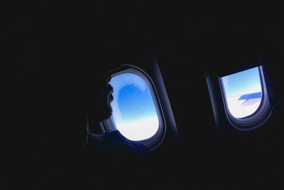 Close-up of man against window