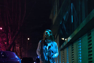 Low angle view of woman standing at night