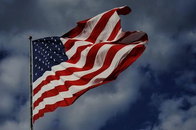 Low angle view of flag against sky