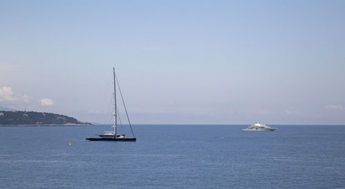 Sailboat sailing on sea against sky