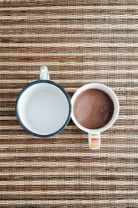 Directly above shot of hot chocolate served in cup on place mat