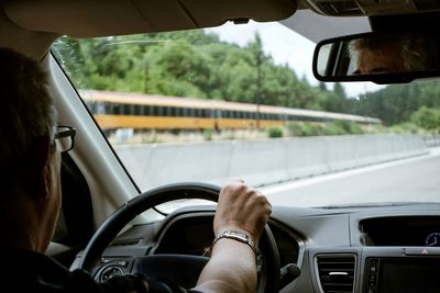 Midsection of man driving car