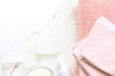 Directly above shot of toiletries on white marble table