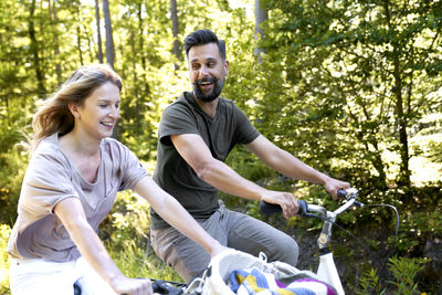 Side view of friends riding bicycle