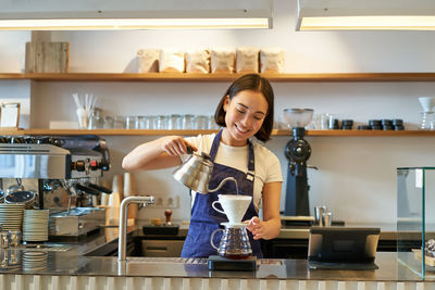 Portrait of young woman working in cafe