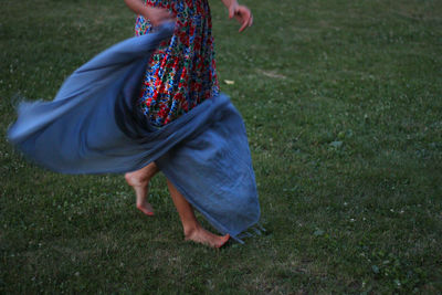 Low section of woman on field