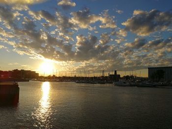 View of river against cloudy sky during sunset