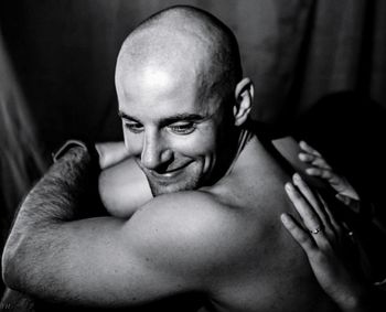 Cropped hands of woman giving back massage to man indoors