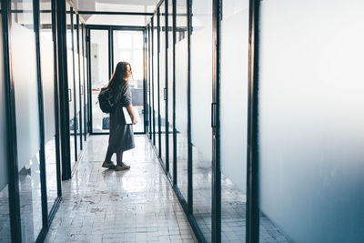 Business woman leaving office.businesswoman walking in office corridor.